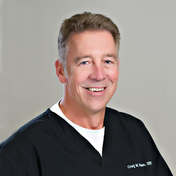 Dr. Hanson smiling while wearing his dentist uniform